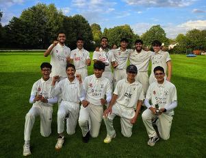 A team photo of Astley Bridge Cricket Club Under 18s celebrating winning the Jake Tatlock Trophy.